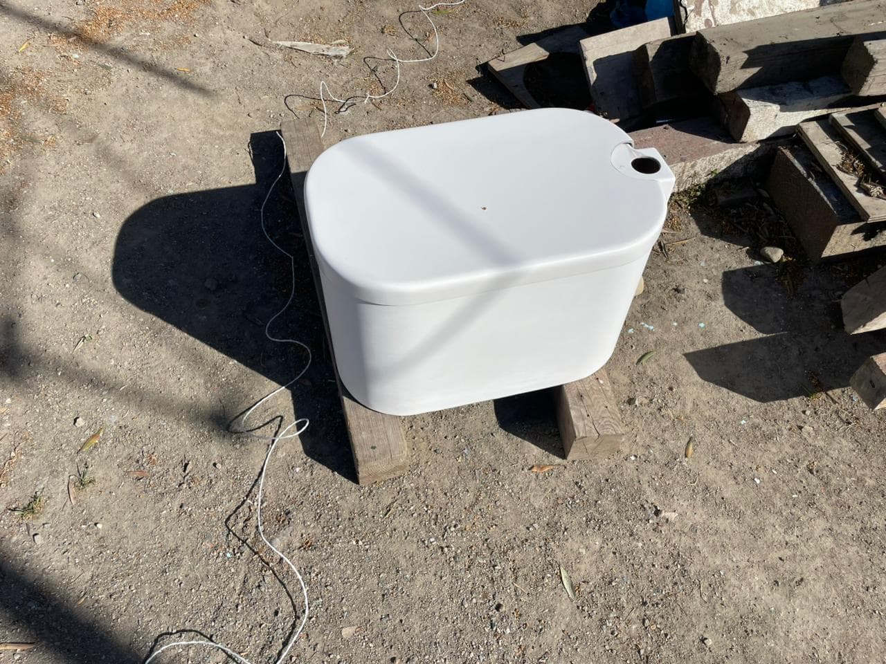 Finished bait tank with lid in the yard